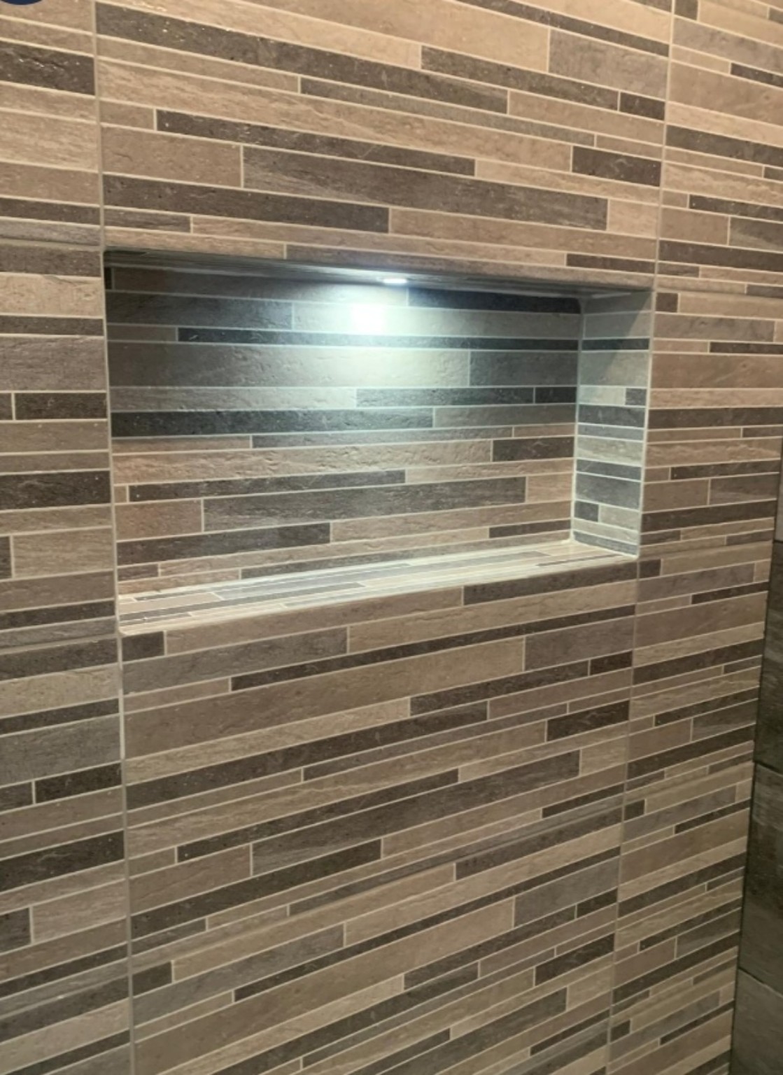 WMB bathroom finishing: illuminated stone tile niche